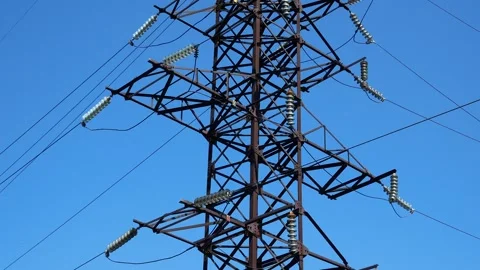 A high-voltage power line pole with wires against a blue sky. Energy Stock Footage 249073523