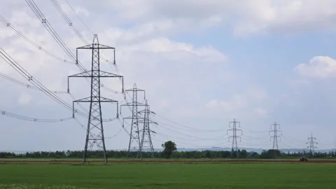 High-Voltage Power Line With Several Poles Running Through An Agricultural Field Stock Footage 293715323