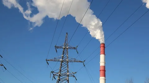 High voltage power line support and smoke from the chimney. Stock Footage 86940066