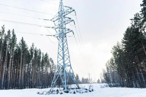 High voltage power line support in winter forest 스톡 사진