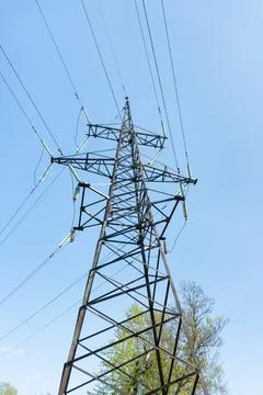 High-voltage power line support against the blue sky 库存照片