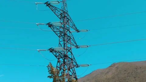 High-voltage power line tower against the background of the blue sky Stock Footage 318739751