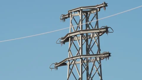 High-Voltage Power Line Tower Against a Vast Sky Stock Footage 323140193