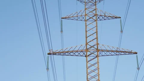 High voltage power line tower against blue sky Stock Footage 345532372