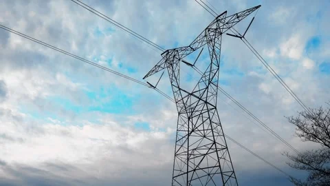 High voltage power lines against a cloudy blue sky Stock Footage 332873958