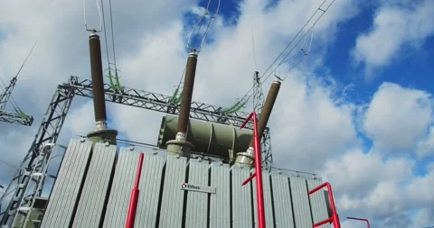 High voltage power lines and a big electrical transformer at the station, 4k Stock Footage 144824811