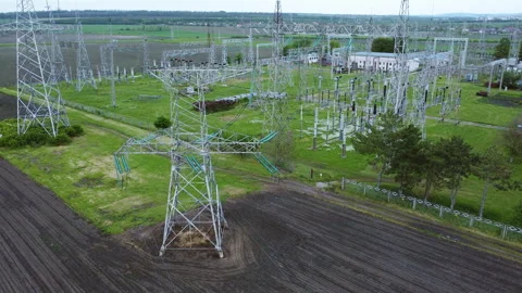 High-voltage power lines and transmission towers are prominently displayed in a Video stock 312744760