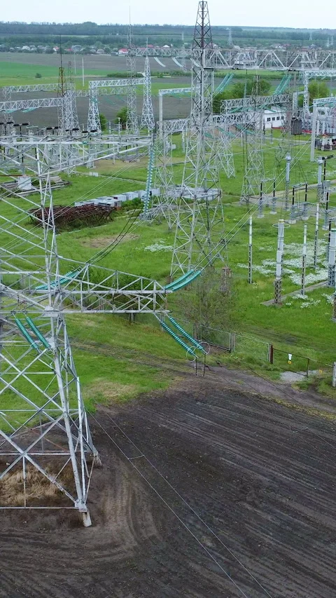 High-voltage power lines and transmission towers are prominently displayed in a Stock Footage 313929785