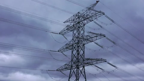 High voltage power lines and transmission tower during cloudy day Stock Footage 327707373