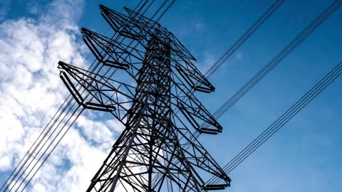 High voltage power lines and electrical pylon against blue sky time lapse Stock-Footage 332873921