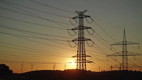 High Voltage Power Lines and Wind Turbines at Sunset Stock Footage 342349611