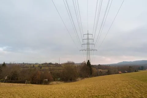 High voltage power lines and transmission tower in a rural landscape near N.. Stock Photos