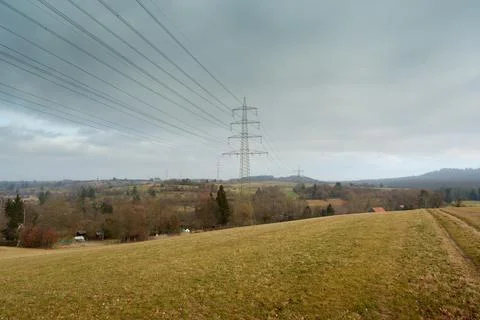 High voltage power lines and transmission tower in a rural landscape near N.. Stock Photos