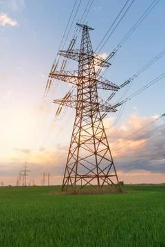 High-voltage power lines on the background of a beautiful cloudy sunset sky. Фото