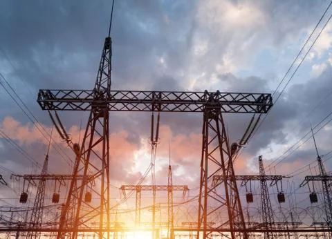 High-voltage power lines on the background of a beautiful cloudy sunset sky. Stockfoto's