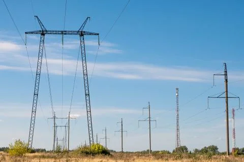 High-voltage power lines on blue sky Stock Photos