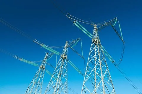 High voltage power lines with blue sky on the background, three electricity.. Stock Photos