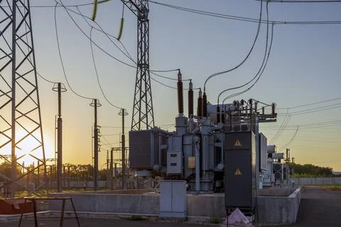 High voltage power lines with luminous wires against the background of the .. Stock Photos