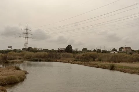High voltage power lines over the river Stock Photos