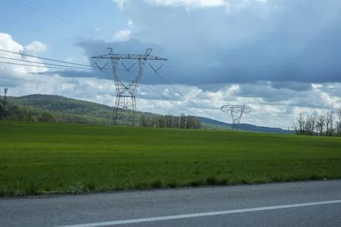 High Voltage Power Lines Over Green Countryside Field Stock Photos