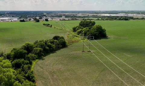 High Voltage Power Lines Over Green Farm Fields Stock Photos