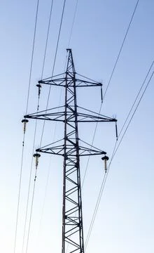 High voltage power lines, post or tower against the backdrop of a beautiful s Stock-Fotos