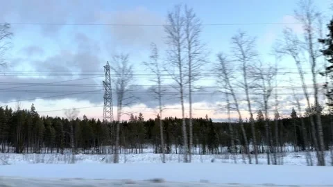 The high-voltage power lines run parallel to the winter road. Stock Footage 317628542