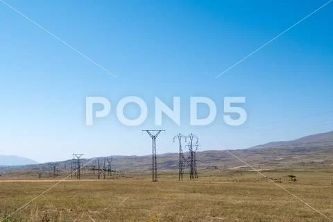 High Voltage power lines in rural landscape Stock Photos