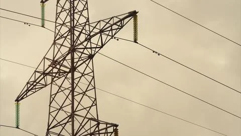 High Voltage Power Lines Set Against a Dramatic and Striking Sky Filled with Clo Stock Photos
