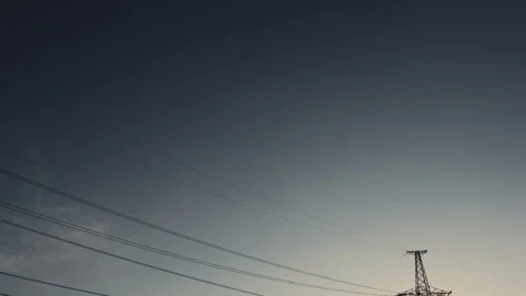 High-voltage power lines at sunset Stockbeeldmateriaal 137455472