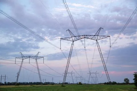 High-voltage power lines at sunset. High voltage electric transmission tower Foto stock