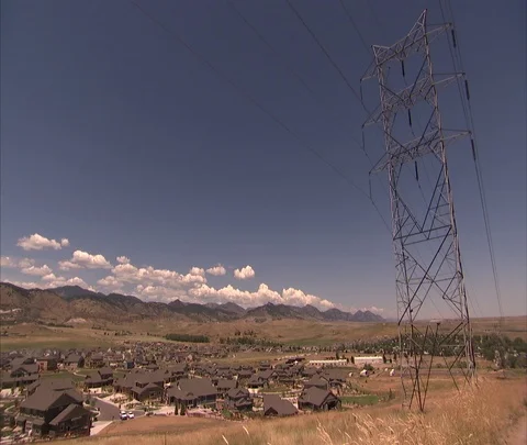 High voltage power lines tower over residential neighborhood Stock Footage 86691646