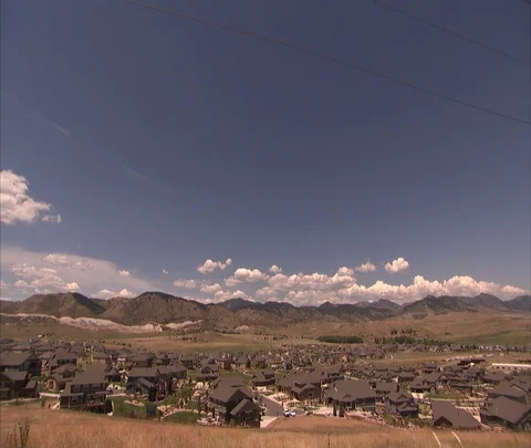 High voltage power lines tower over residential neighborhood Stock Footage 86691672