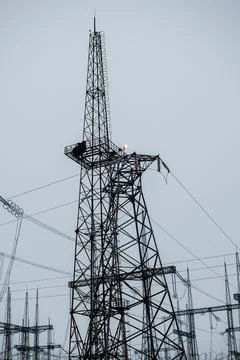 High-voltage power lines. Vertical photo. Transmission of electricity. Stock Photos