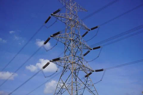 High-voltage power pole with a bright blue sky background 스톡 사진