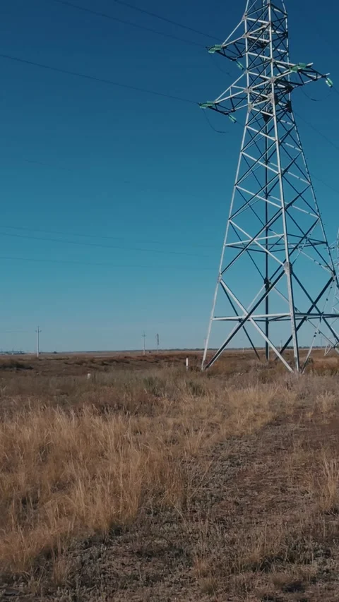 High voltage power poles and cables with steel supports in the field, Stock Footage 346030914