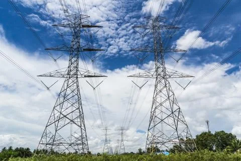 High voltage power pylon against blue sky Stock Photos