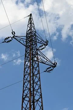 High voltage power pylon against blue sky Fotos Stock
