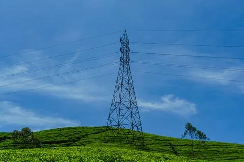 High voltage power tower and electrical lines against sky Stock Photos