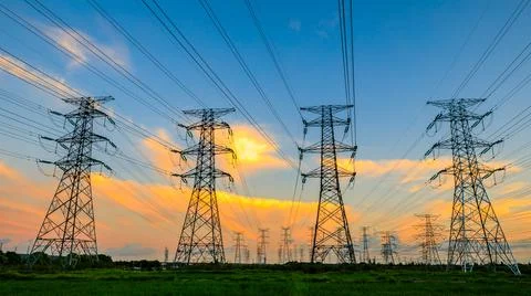 High voltage power tower industrial landscape at sunrise. Stock Photos