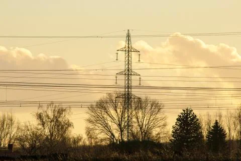 High voltage pylon with cables and landscape Stock Photos