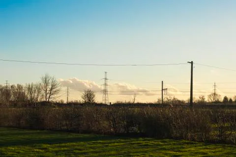 High voltage pylon with cables and landscape Stock Photos