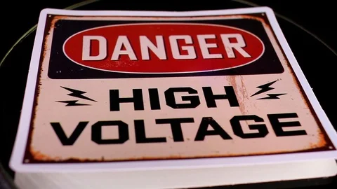 High voltage sign closeup texture video on rolling rotating looping plate Video stock 104328373