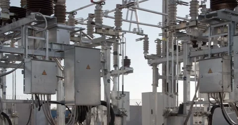High voltage substation with metal structures and electrical wires against sky 스톡 동영상 329100776