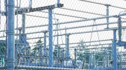 High voltage substation safety warning signs on chain link fence perimeter 動画素材 342598782
