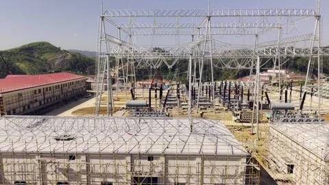 High Voltage Substation Under Construction with Solar Panels on Hillside Vídeos de archivo 344440353