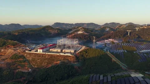 High Voltage Substation Under Construction with Solar Panels on Hillside 스톡 동영상 344441058