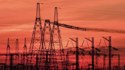 A high voltage substations, in the sunset. Transmission power lines. Timelapse Stockbeeldmateriaal 74334441