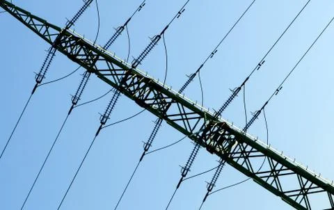 High voltage tower and cabels againts blue sky. Stock Photos
