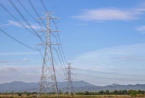 High voltage tower with blue sky background. Stock Photos